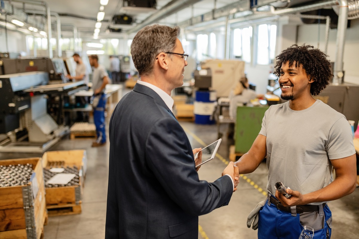 Manager and technician shaking hands